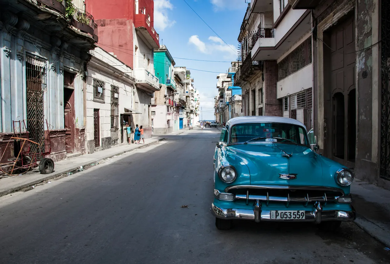 Antique blue American taxi parked in a street in Old Havana. Photo by Daniel Klein.