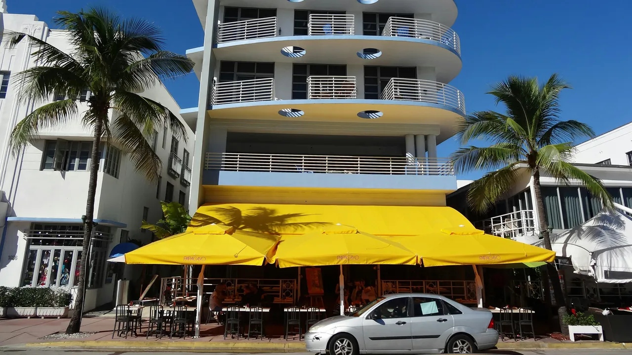Car driving by a hotel in the beach. Photo by Andre Schellenberg.