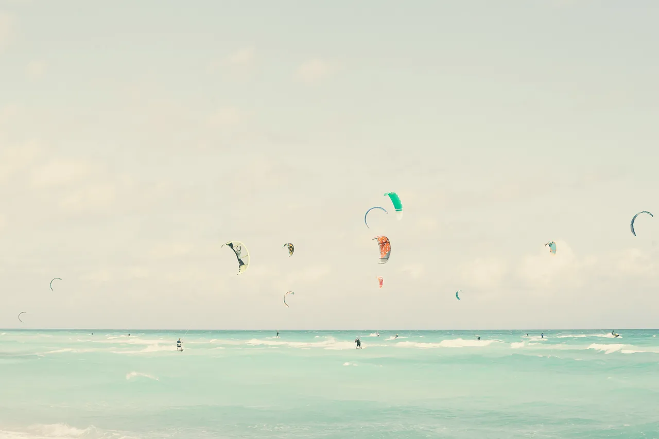 Parashooters landing in the beach water. Photo by Marten Soerensen.